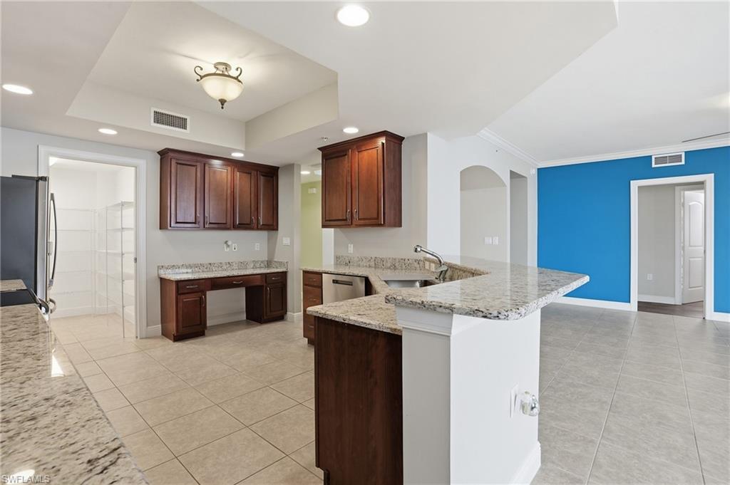 Kitchen featuring a peninsula, granite countertops, light tile  flooring, stainless steel appliances, and recessed lighting