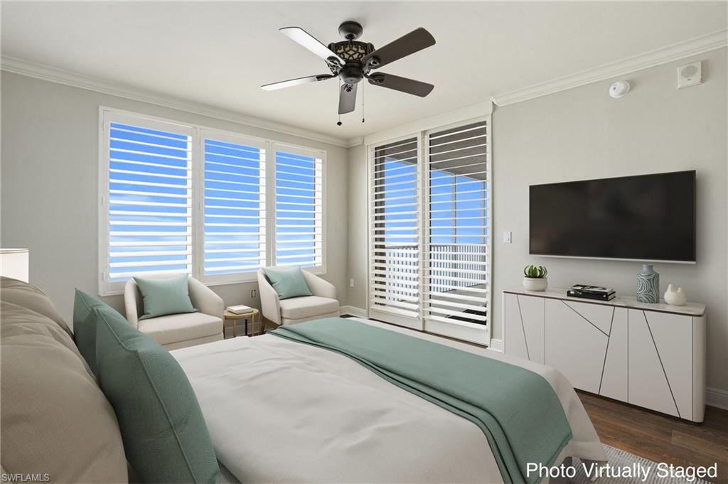 Virtually Staged Primary ensuite with ceiling fan, hard wood finished floors, and crown molding