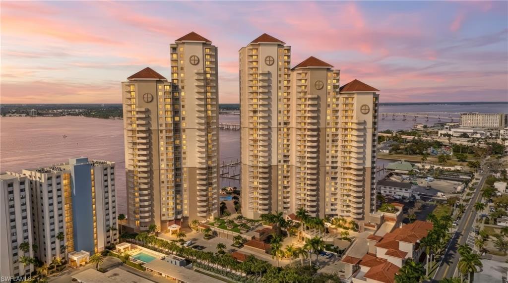 View of building exterior with a water view and a view of city