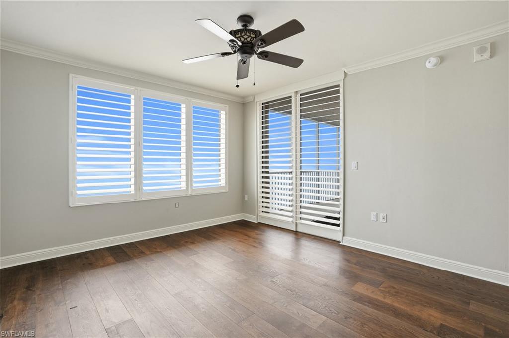 Primary ensuite with ceiling fan, hard wood finished floors, and crown molding