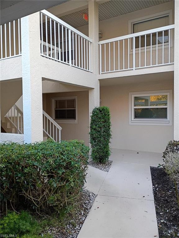 View of exterior entry featuring stucco siding