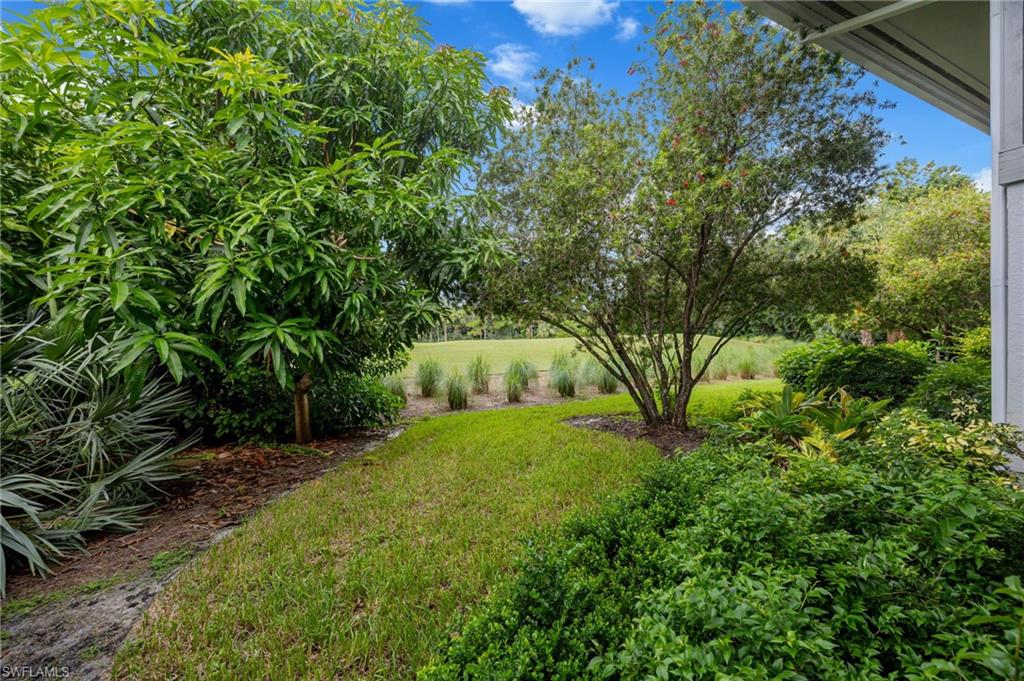 Landscaped grounds featuring mature trees and diverse plantings