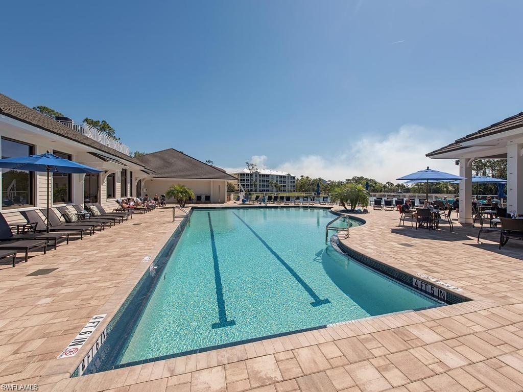 Community pool featuring a patio and outdoor dining area