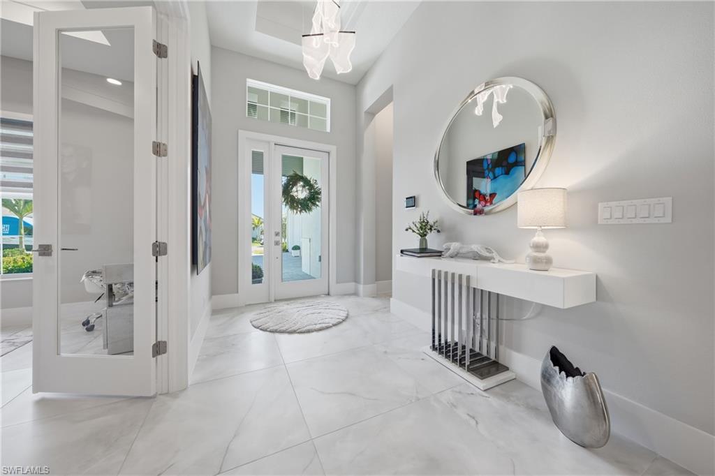 Welcoming foyer with elevated ceiling detail and clean architectural lines creating an immediate sense of scale.