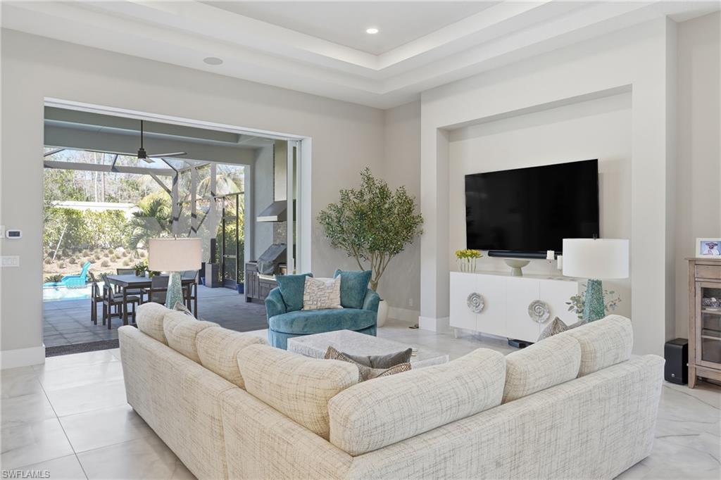 Open concept living area enhanced by upgraded lighting and a seamless indoor outdoor connection.