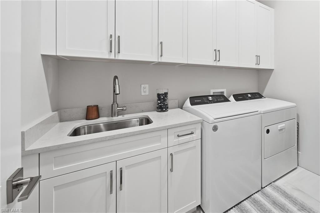 Dedicated laundry room with built in cabinetry and functional workspace.