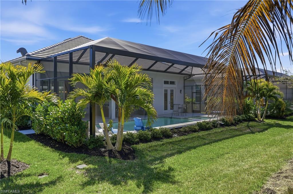 Private backyard retreat surrounded by tropical landscaping and tranquil green views.