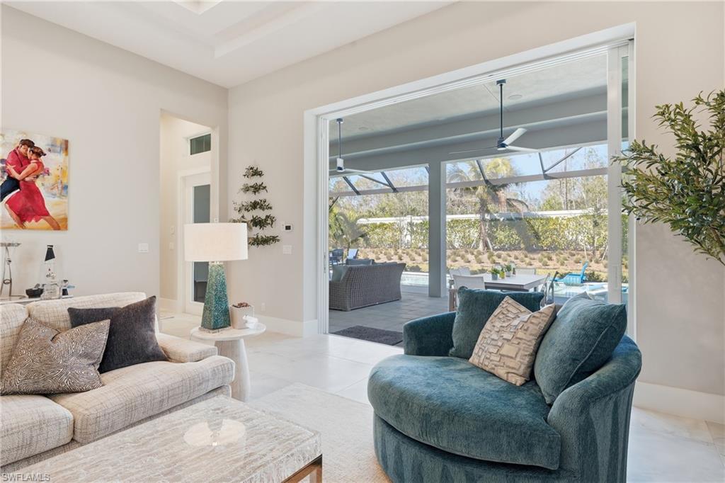 Light filled living space anchored by clean architectural lines and open flow into the kitchen and dining areas.