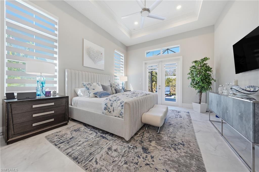 Light filled owner’s suite featuring expansive windows, soft neutral tones and seamless flow into a spa inspired bath.