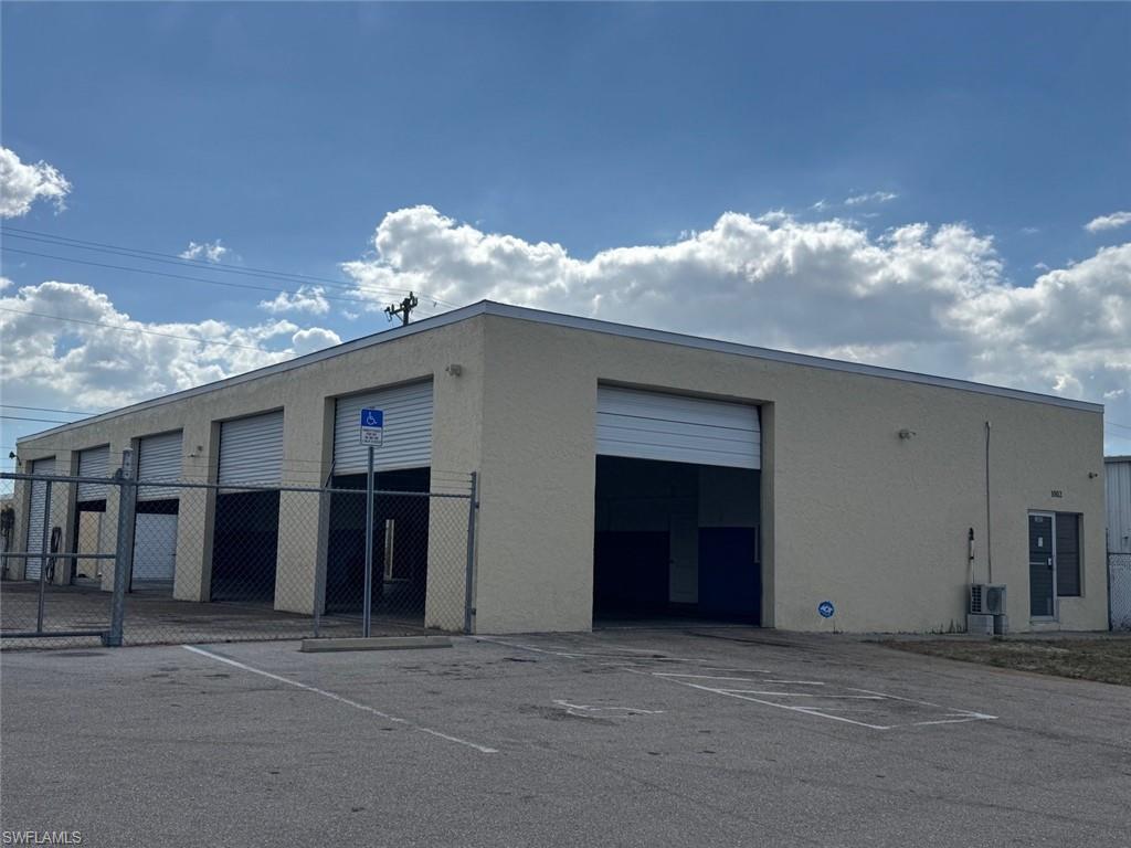 View of building exterior with uncovered parking