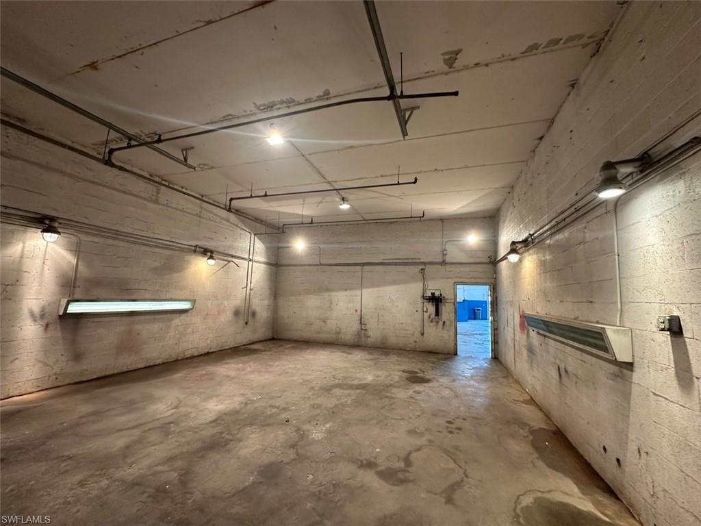 Garage featuring concrete block wall
