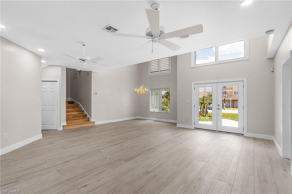 Unfurnished living room with french doors, recessed lighting, light wood-type flooring, a ceiling fan, and plenty of natural light
