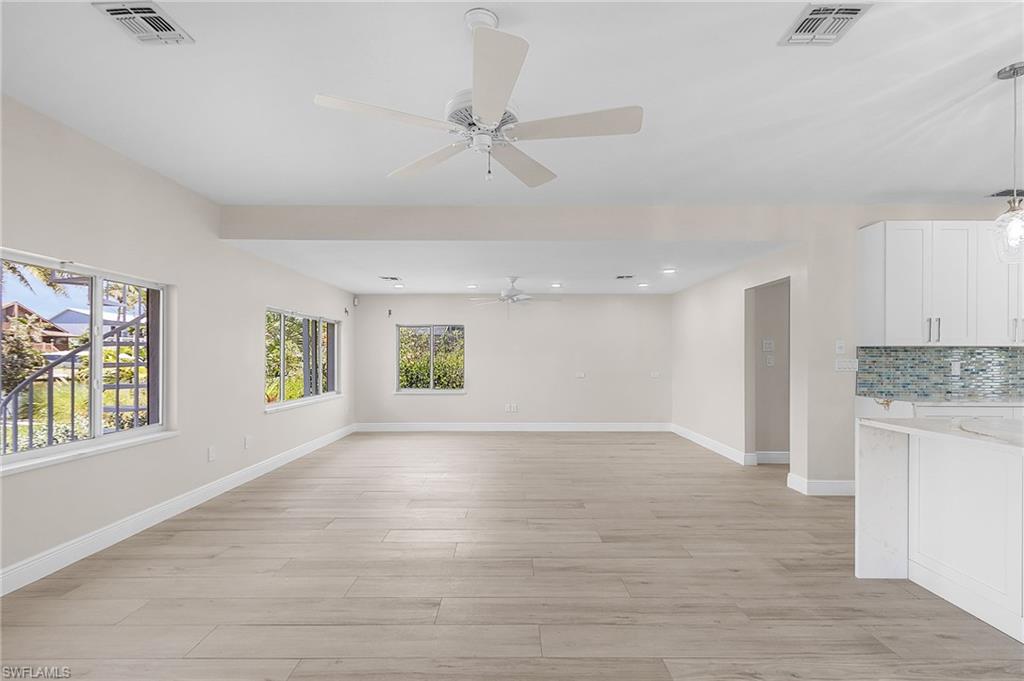 Family room featuring light wood-type flooring, plenty of natural light, ceiling fan, and recessed lighting