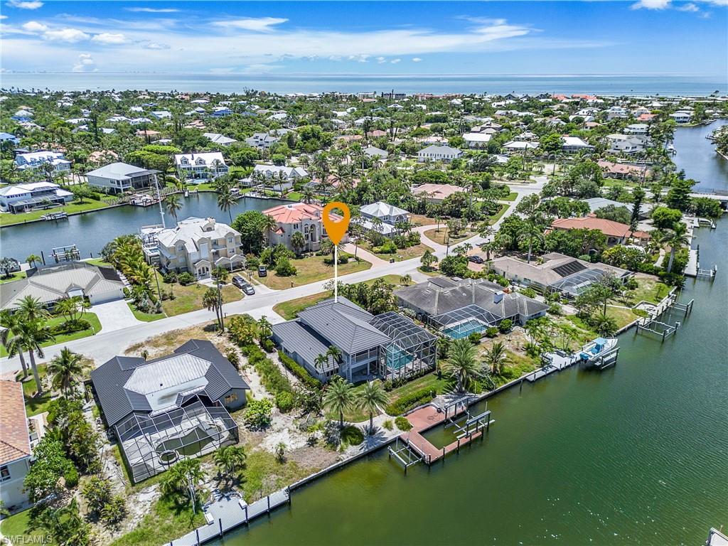 Aerial view of residential area featuring a nearby body of water