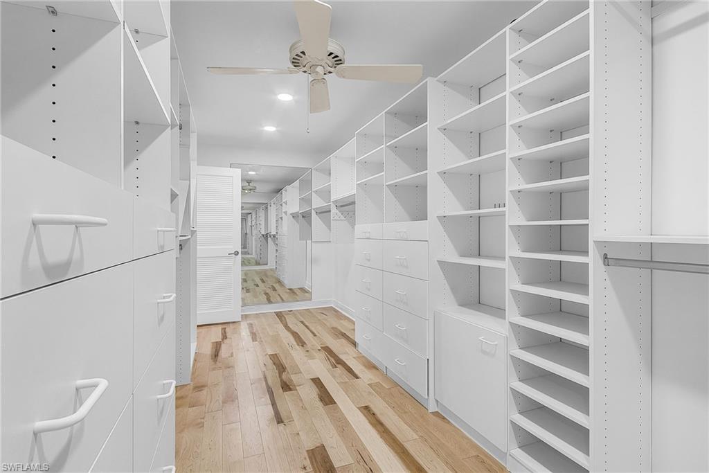 Walk in closet featuring light wood-style floors and ceiling fan