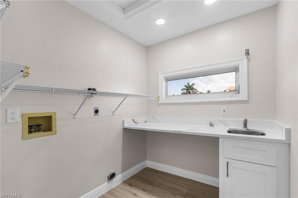 Laundry room featuring light wood-style floors, hookup for an electric dryer, and washer hookup