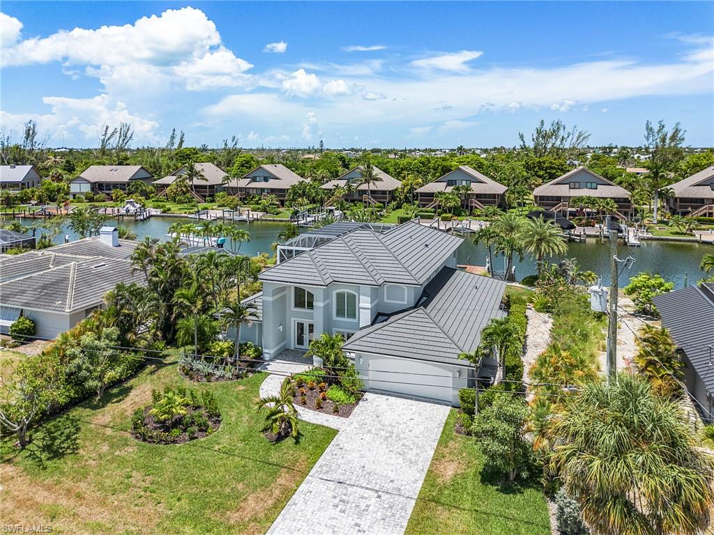 Aerial perspective of suburban area featuring a nearby body of water