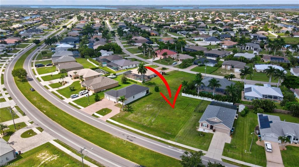 Aerial view of property's location featuring nearby suburban area