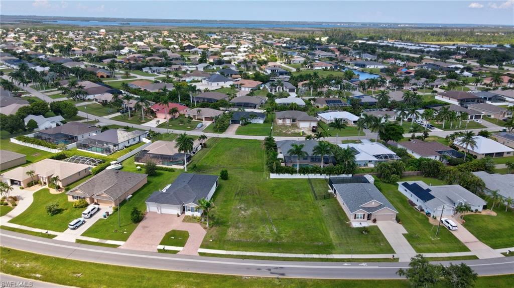 Aerial view of property's location with nearby suburban area