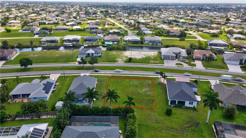 Aerial view of residential area featuring property boundaries highlighted