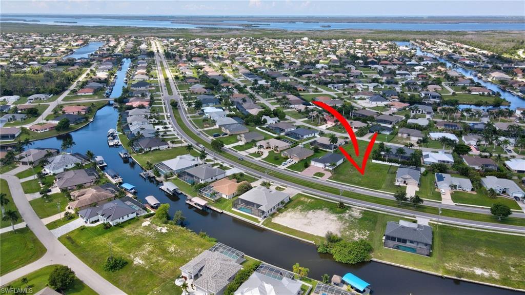 View of property location featuring nearby suburban area and a nearby body of water