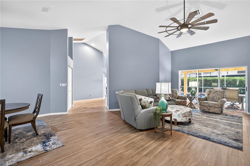 Living area featuring ceiling fan, light wood finished floors