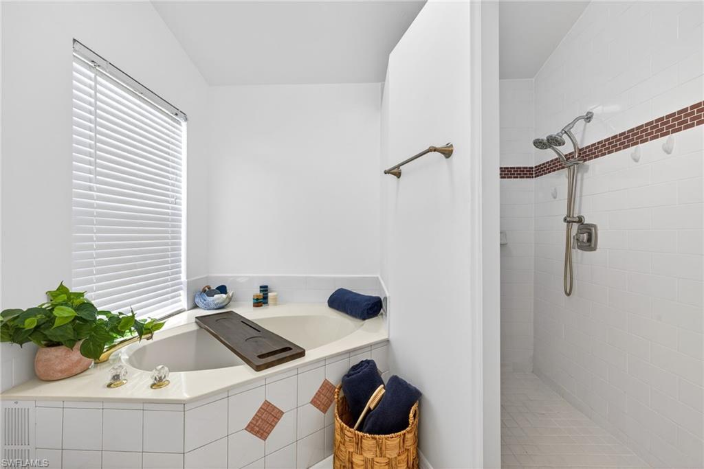 Bathroom featuring a garden tub and a walk in shower