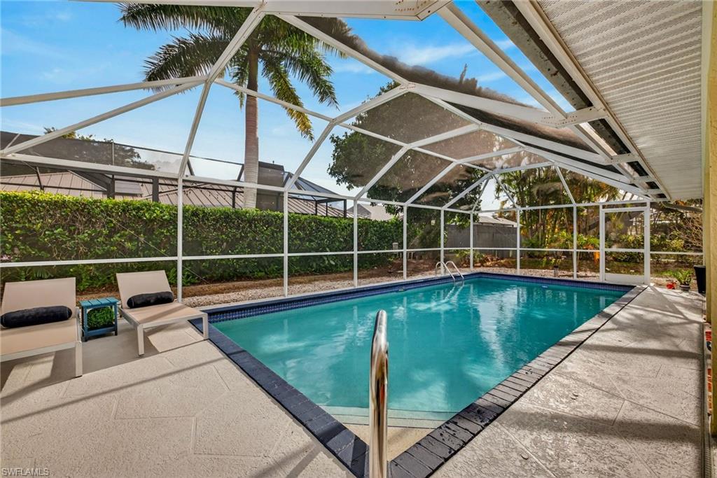 View of swimming pool with screened in lanai