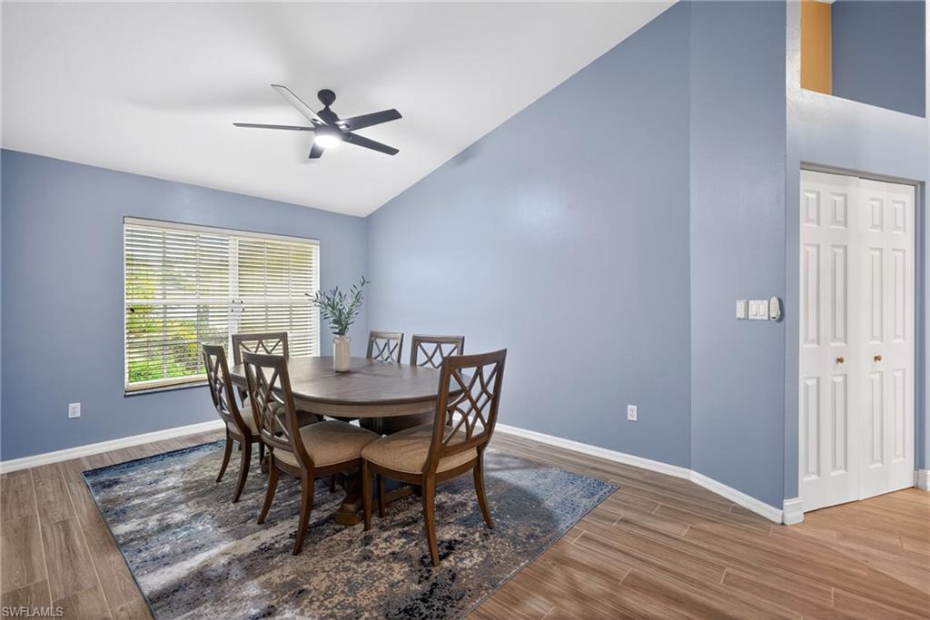 Dining area featuring lofted ceiling, ceiling fan, and light wood-type flooring