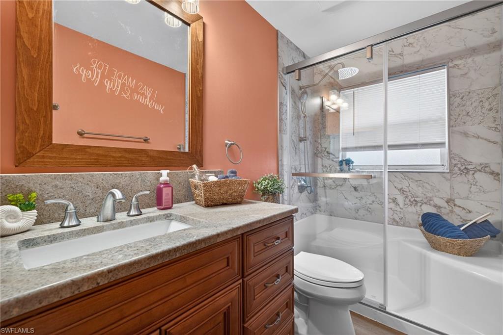 Full bathroom with vanity and a marble finish shower