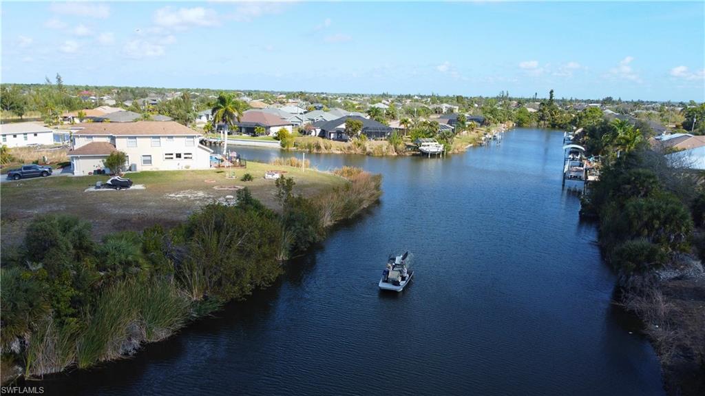 Aerial view of residential area featuring a large body of water