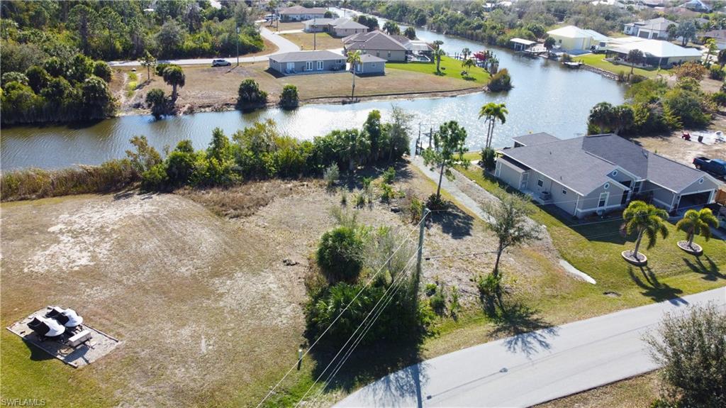 Aerial view of residential area featuring a nearby body of water