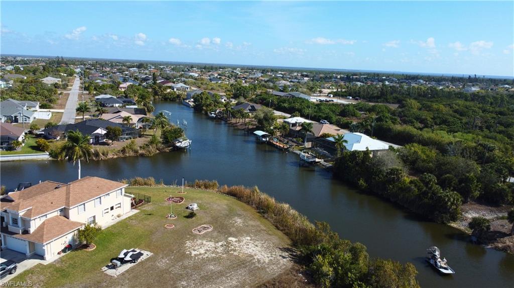 View of property location with a nearby body of water and nearby suburban area