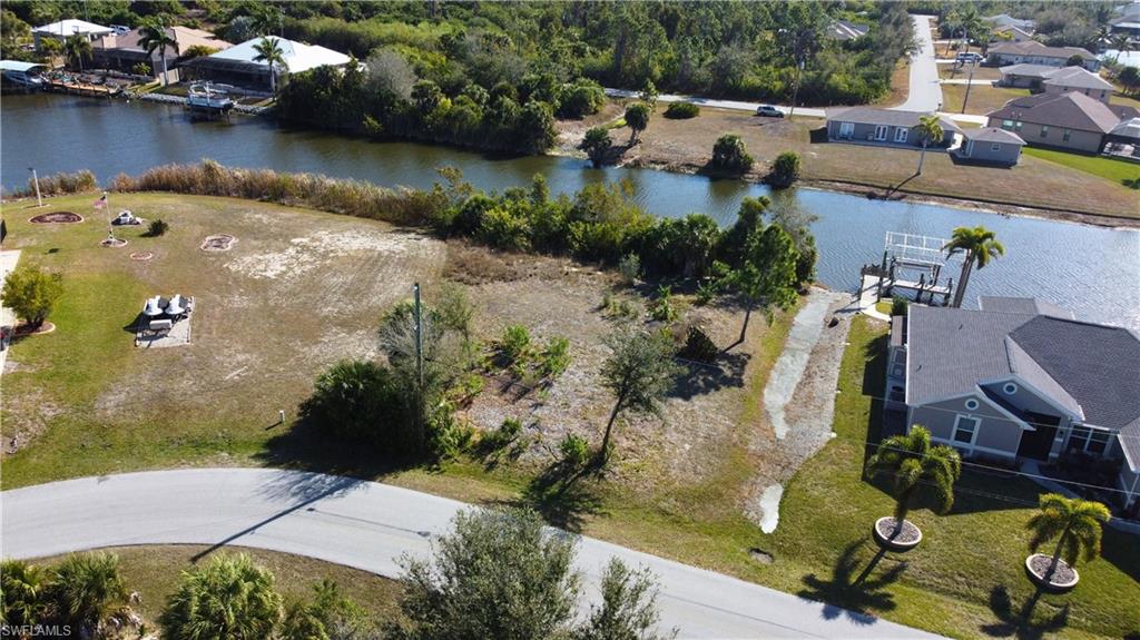 Aerial view of residential area featuring a nearby body of water