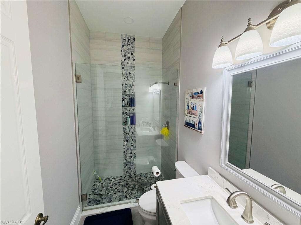 Bathroom with vanity and a stall shower