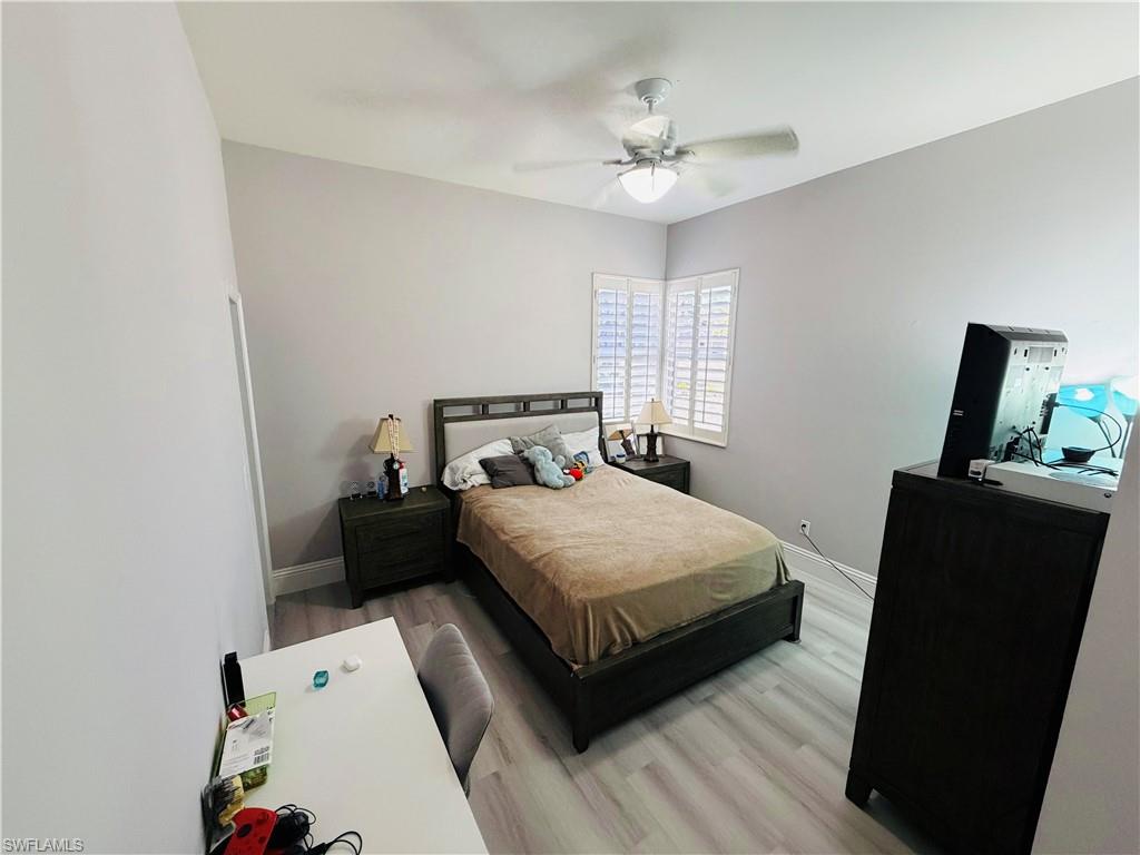 Bedroom with light wood finished floors and a ceiling fan