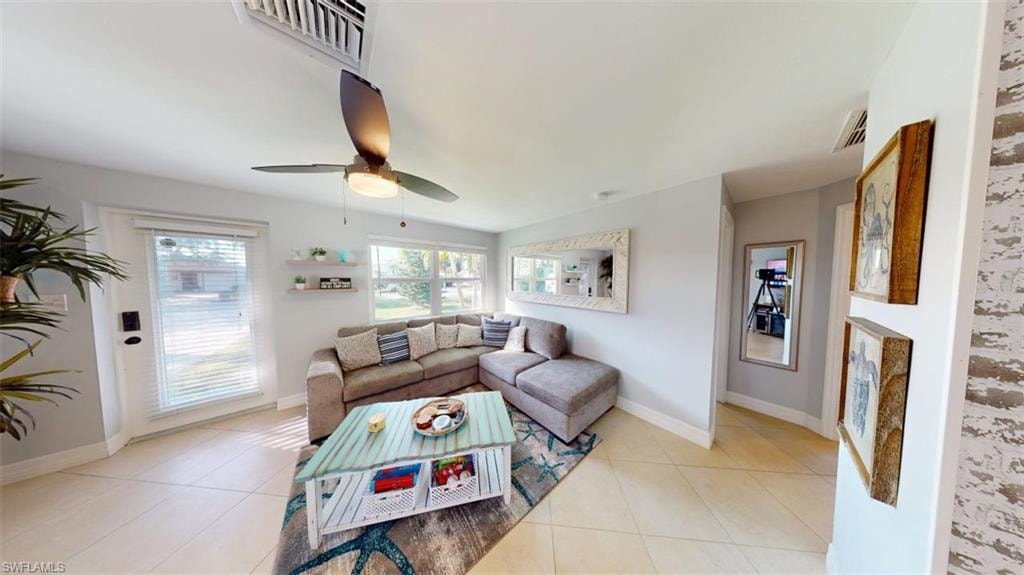 Living area with light tile patterned floors and a ceiling fan