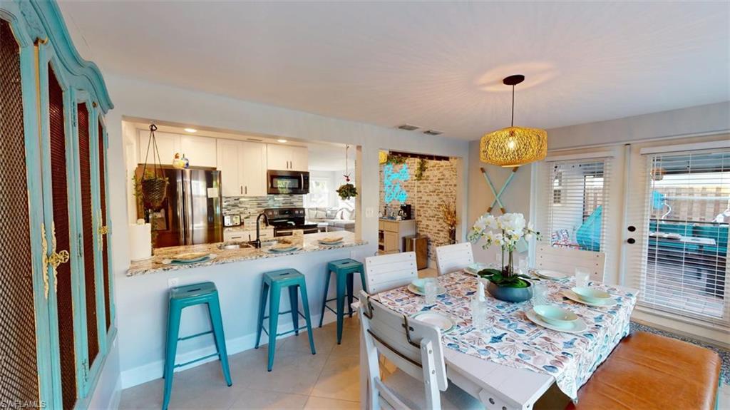 Dining area featuring light tile patterned flooring and a heating unit