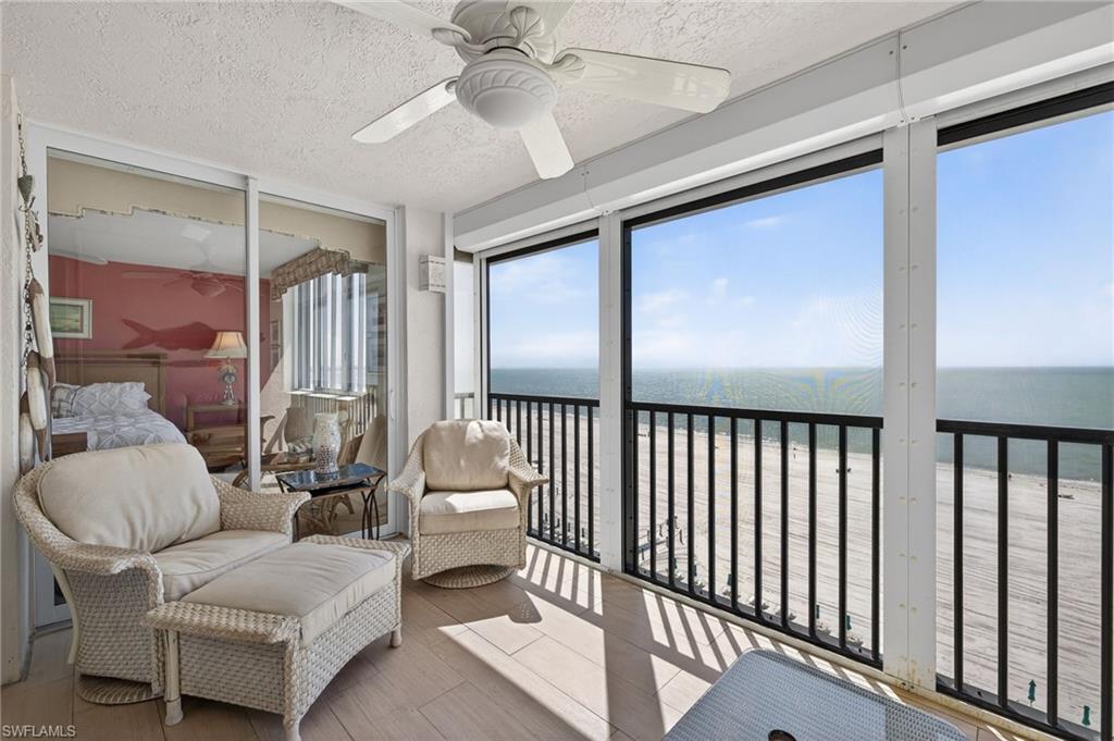 Balcony with view of water and beach