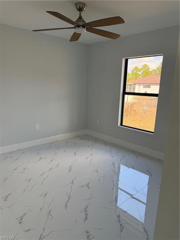 Empty room featuring marble finish flooring and ceiling fan