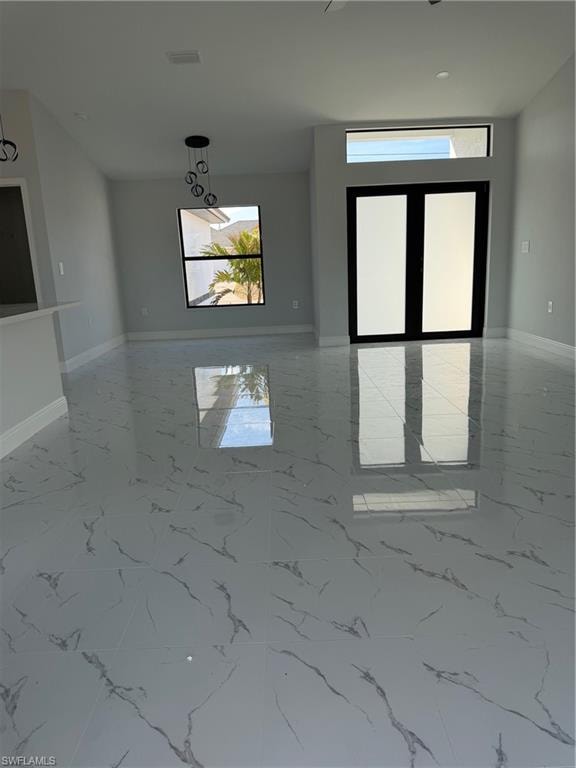 Unfurnished room with baseboards
