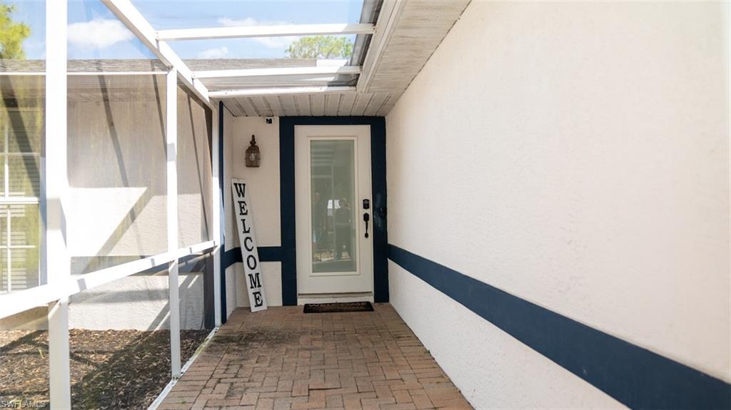 View of exterior entry featuring stucco siding