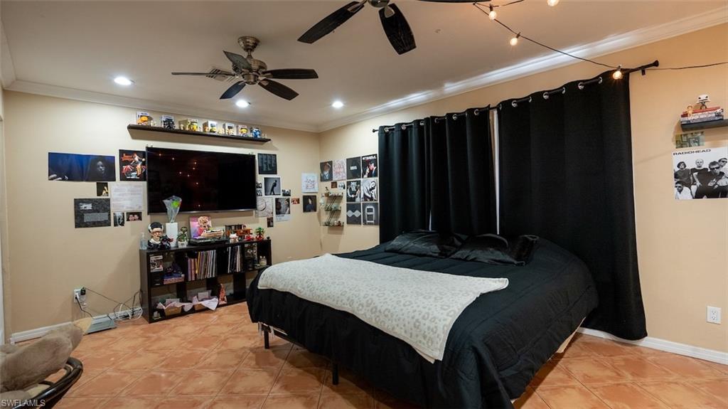 Bedroom with crown molding and recessed lighting