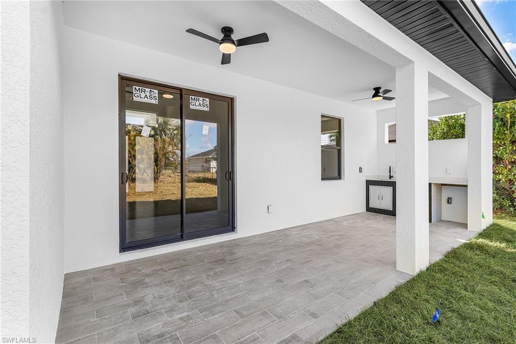 View of patio / terrace featuring a ceiling fan and an outdoor kitchen