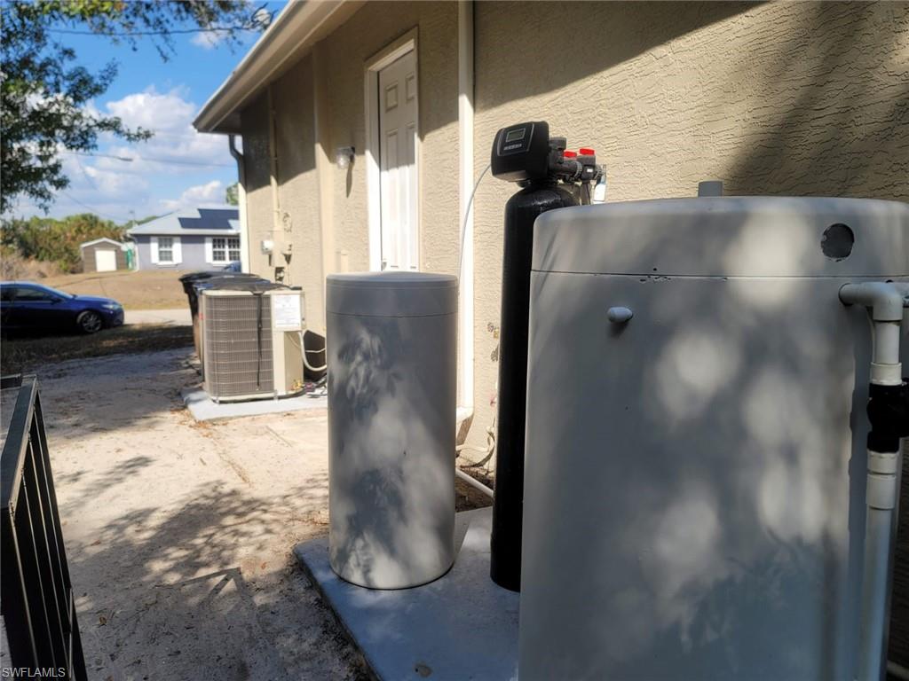 Exterior view of a water softener and stucco siding