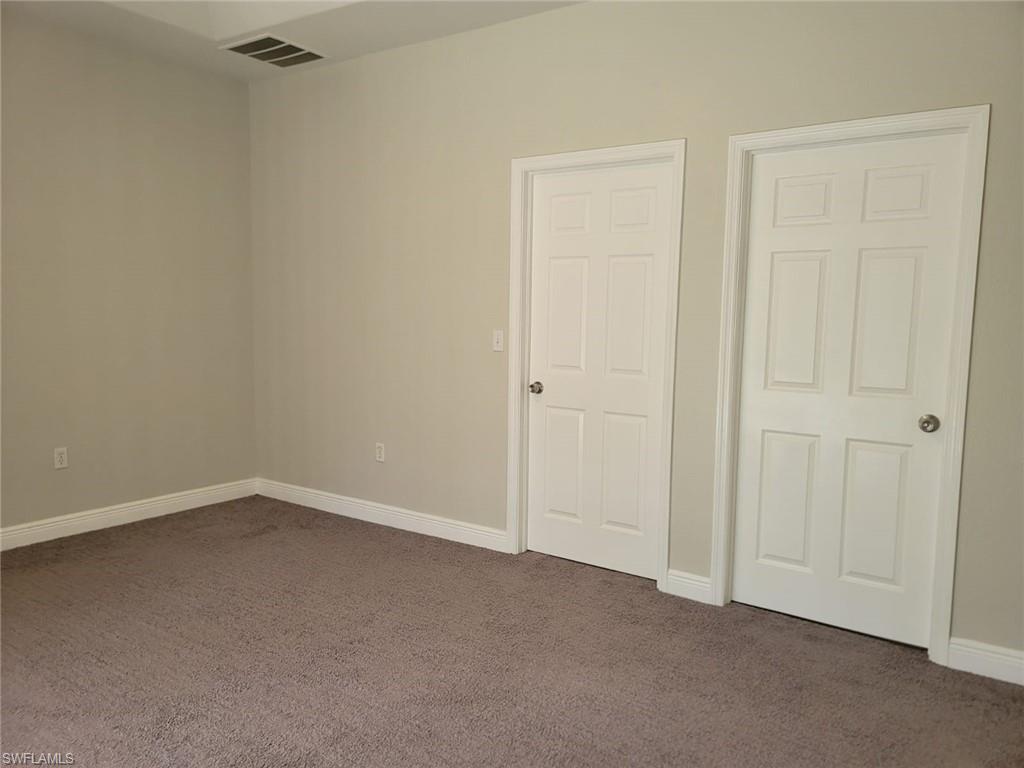 Unfurnished bedroom featuring carpet floors and baseboards