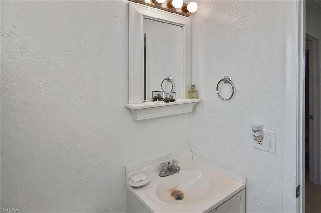 Bathroom featuring vanity and a textured wall