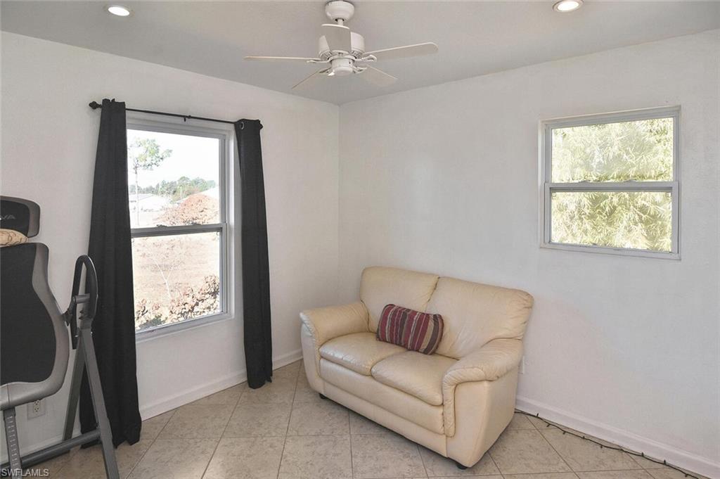 Doorway to outside featuring tile patterned floors and recessed lighting