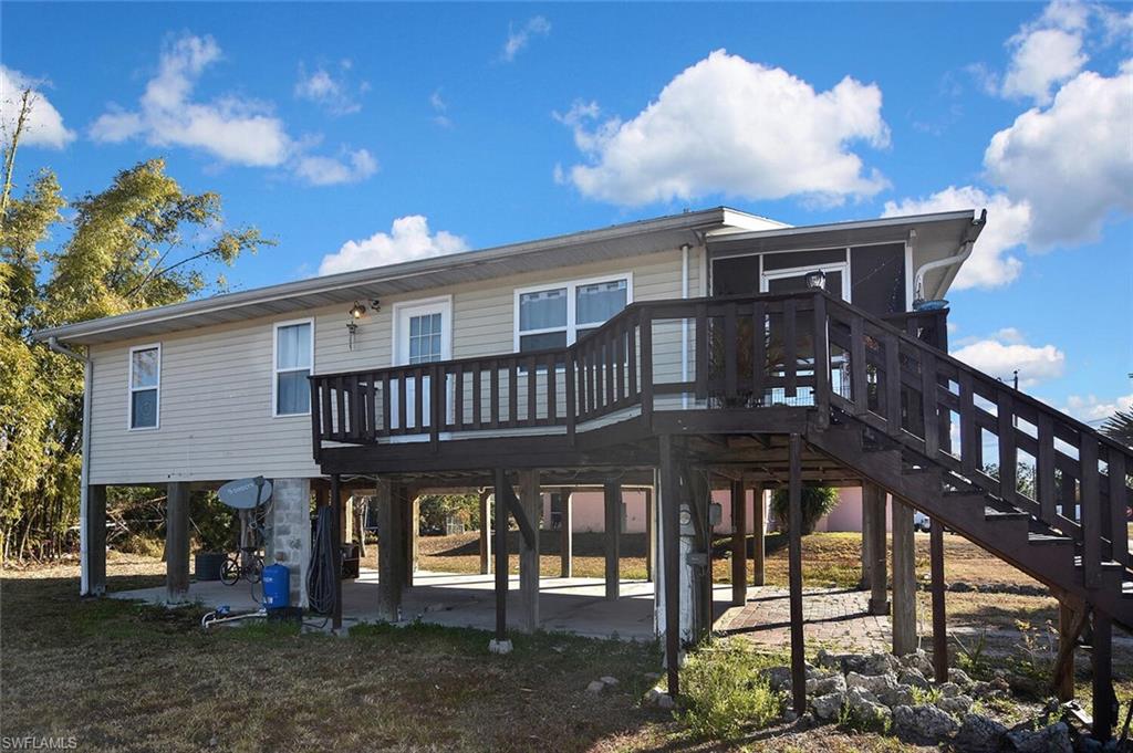 Rear view of property with a deck and a patio