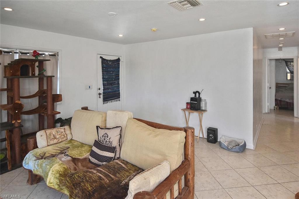 Living area featuring light tile patterned floors and recessed lighting